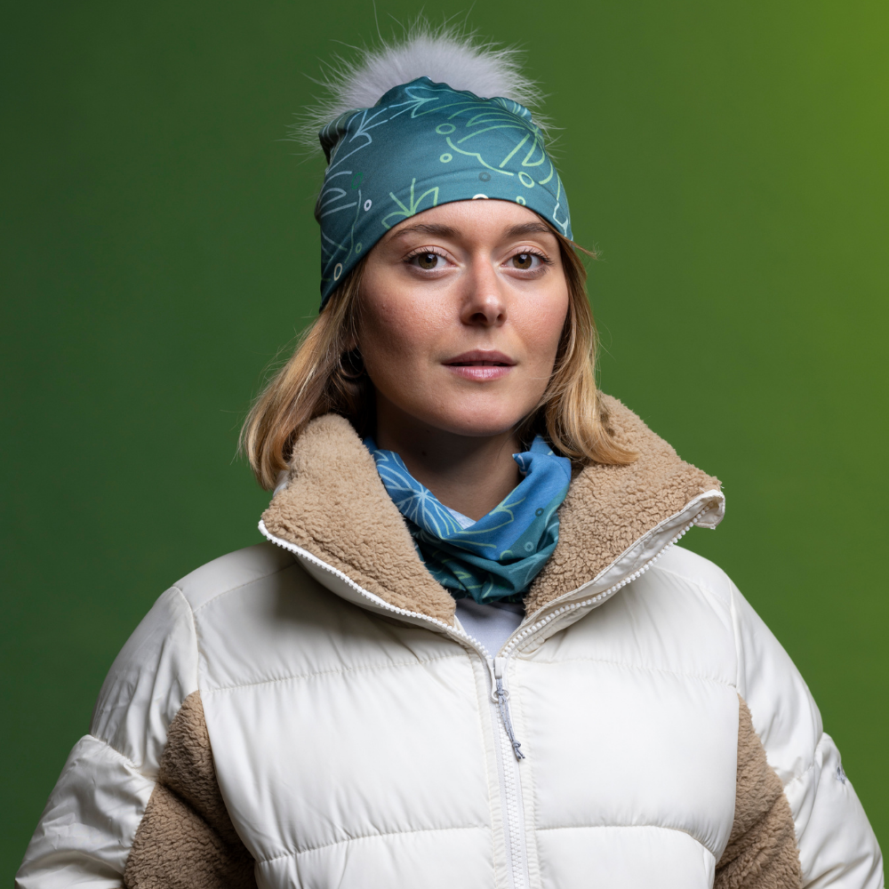 Woman wearing the Turquoise Wallpaper multifunctional tube with a pompom toque for the Lalita&
