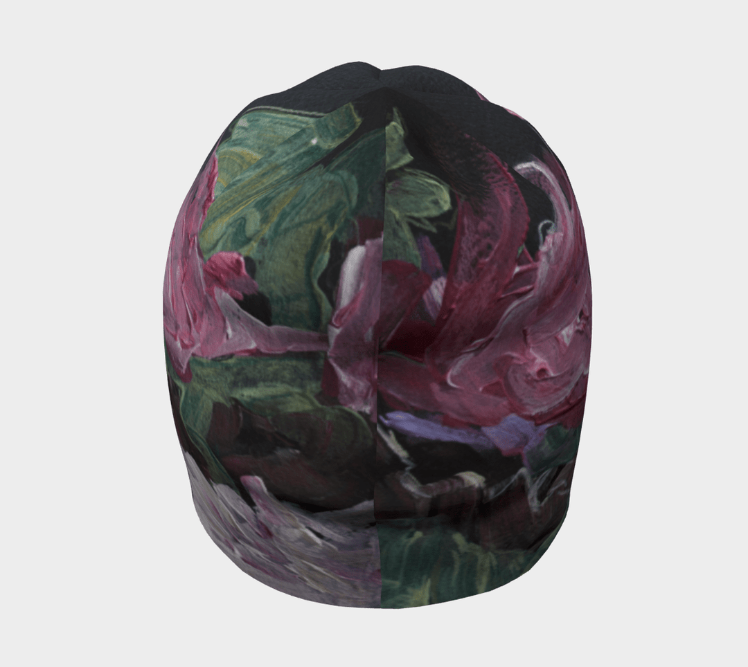 A black beanie with a pink and green floral art print shown from the front and side.