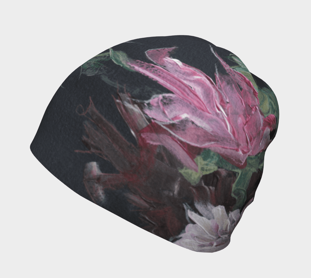 A black beanie with a vibrant pink and green floral art print shown from the side.