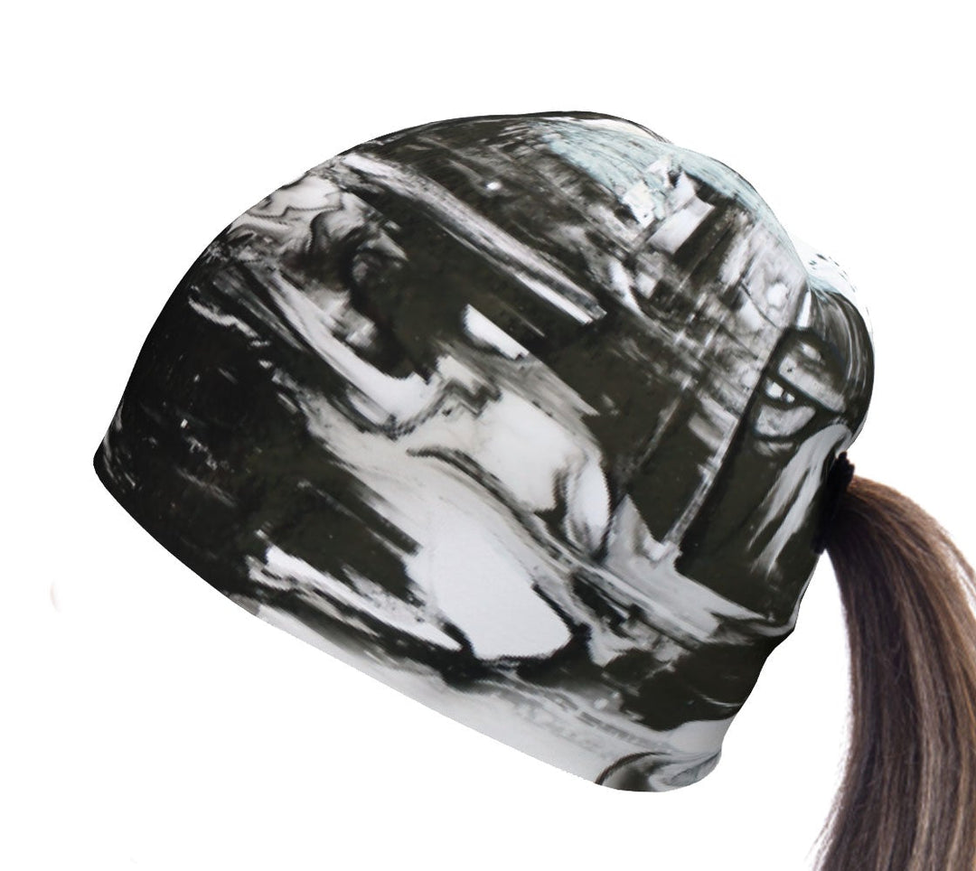 Black and white abstract print beanie with a ponytail hole shown from the side