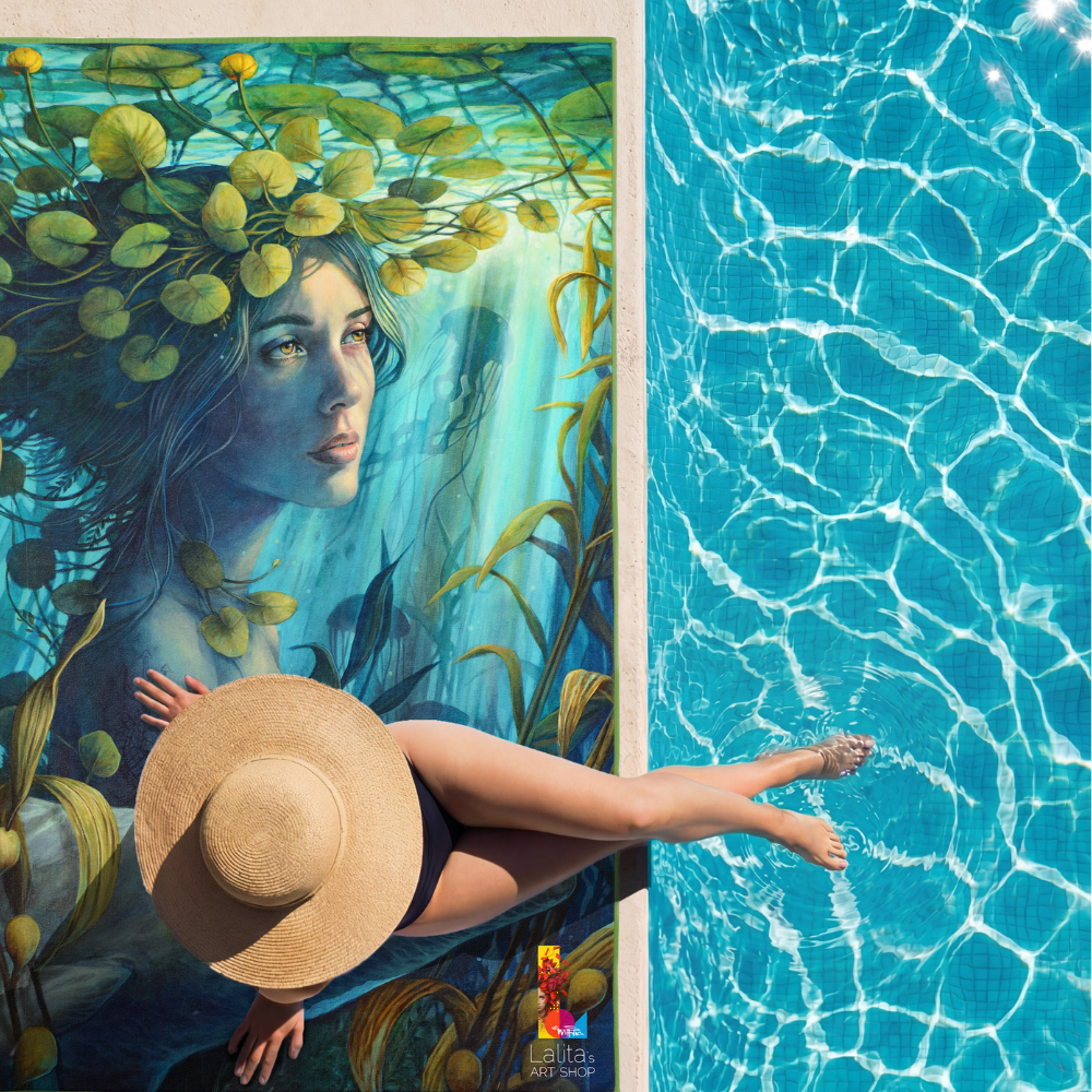 Overhead view of a woman relaxing by a pool, holding a straw hat, with the artistic side of the XL towel spread out beside her.