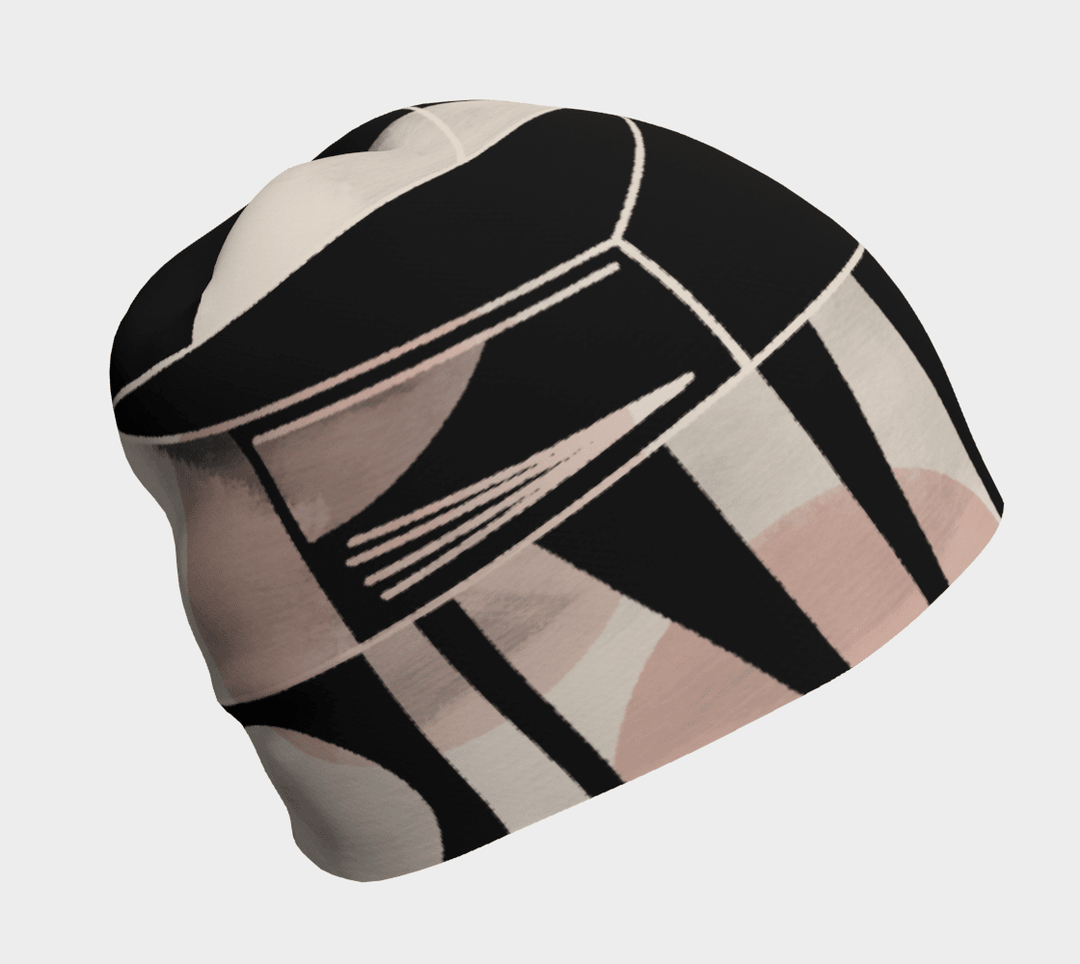 A women's beanie with a black, pink, beige, and white geometric abstract pattern.