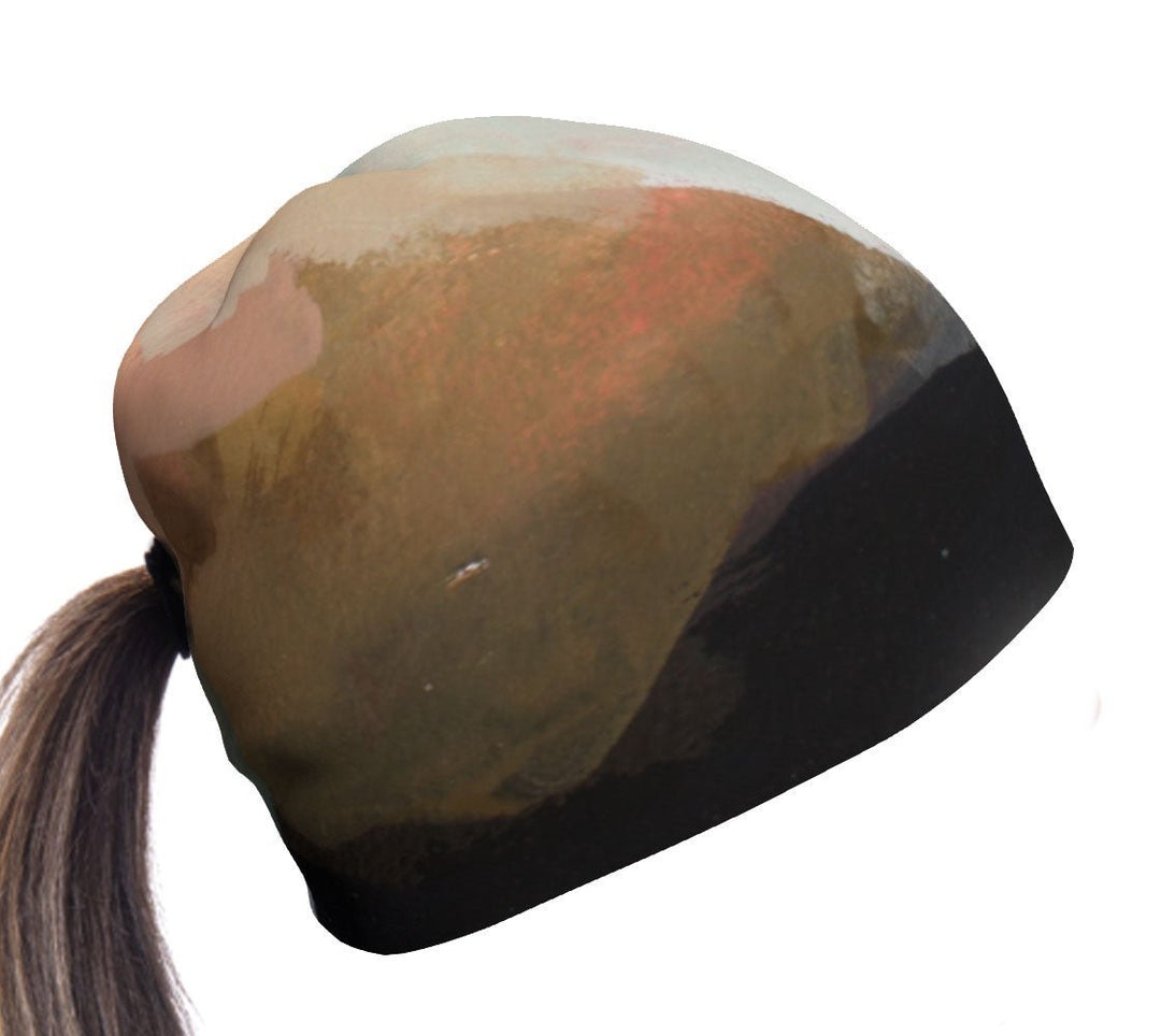 Navy Accent Ponytail Beanie with abstract art design on white background, hair pulled through the back.