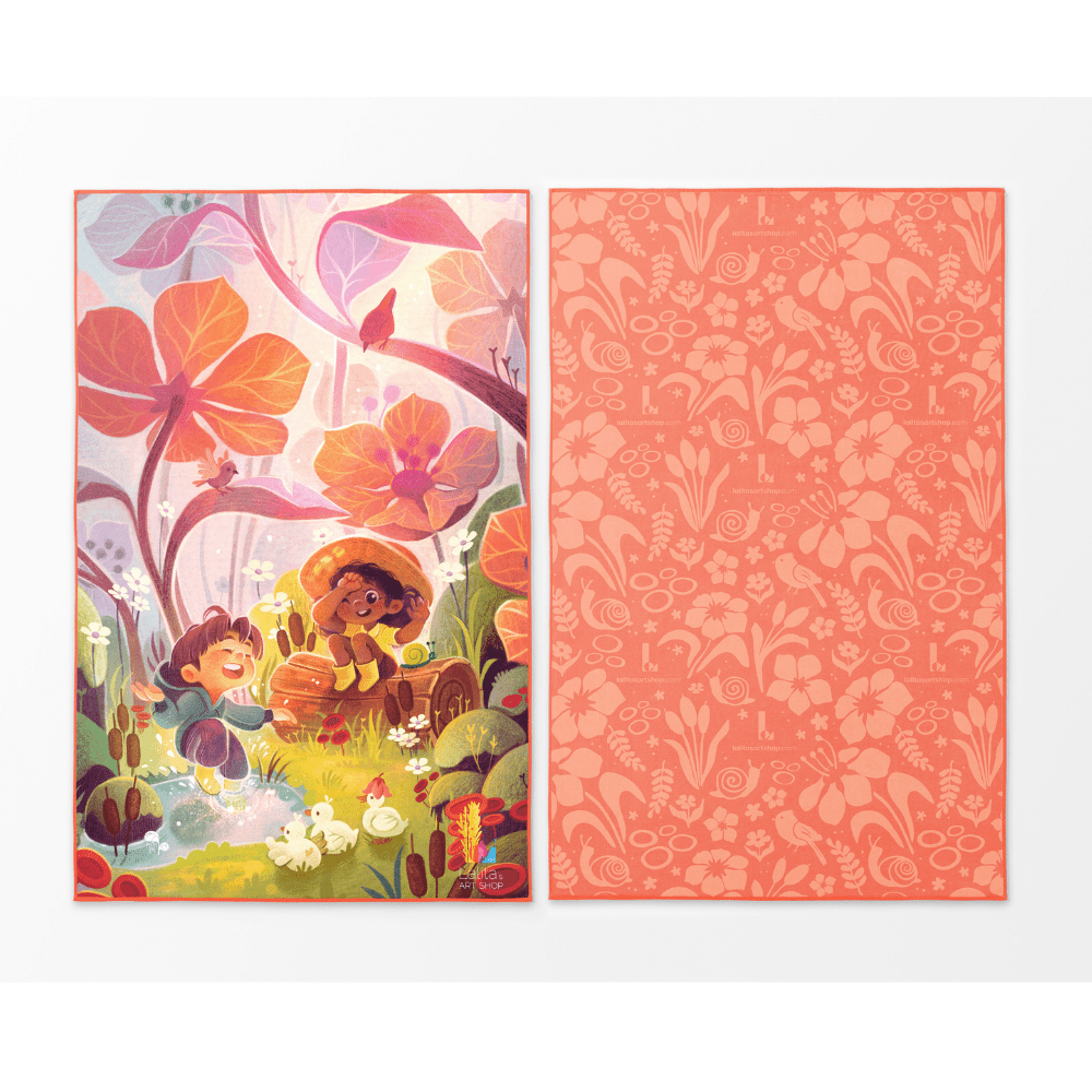 Two sides of the Playful Rain kids' towel displayed flat, left showing a colorful illustration of kids and ducks, right showing a coral floral pattern.