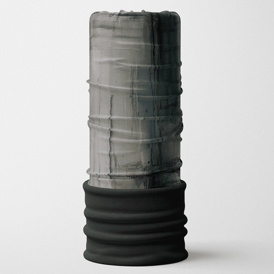 A tall, cylindrical multifunctional neck tube with a black, textured bottom band and a grey and black abstract print resembling concrete or stone on the upper portion.