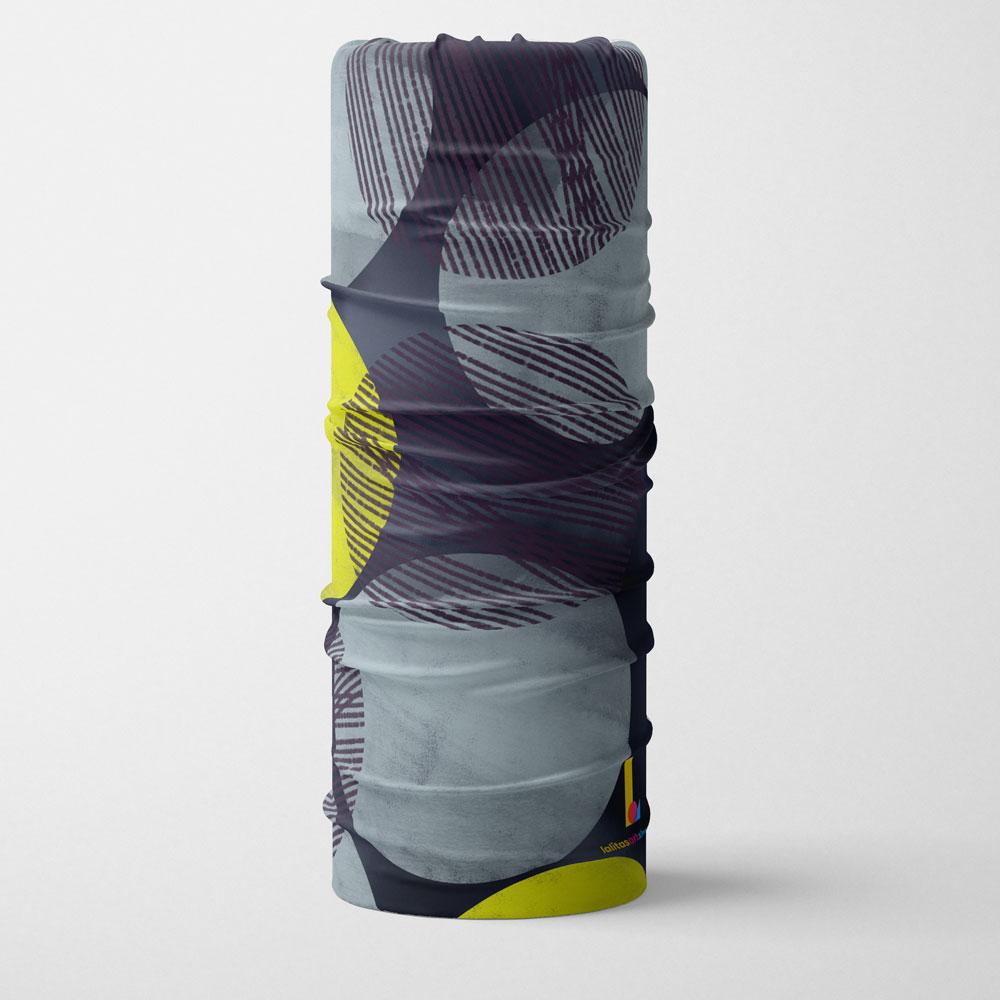 Le tube multifonctionnel Pois Jaunes présenté à la verticale, affichant son design circulaire abstrait jaune et gris.