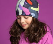 Girl wearing Lalita's Art Shop colourful sport beanie hat by Ankhone