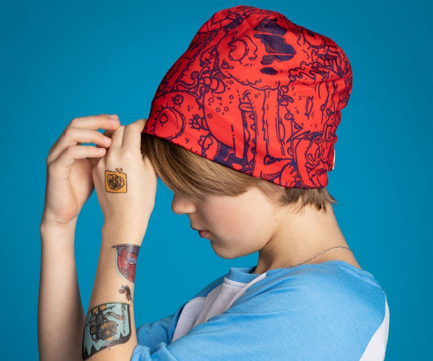 Boy wearing the red and blue Lalita'S Art Shop Monsters beanies hat by artist Andre Martel