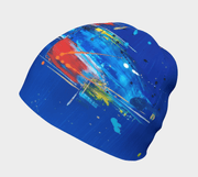 Left side view of the blue, and red and white abstract patterned toque illustrated by artist Megan Fortin