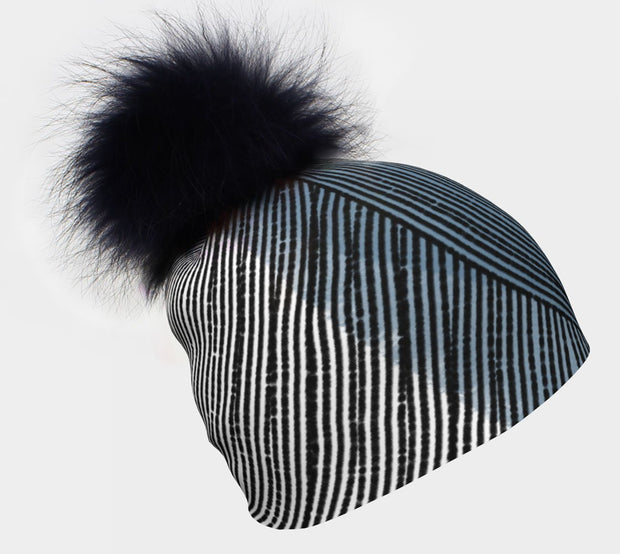 Left view of the Black fur pompom beanie Abstract Lines illustrated by professional artist valery Goulet