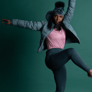 Sporty black woman dancing with her arms in the air. Our Flora bamboo beanie is perfect for indoor and outdoor sports activities. Perfect for yoga, dancing, running or walking. It's soft and stylish and will look great with any outfit.