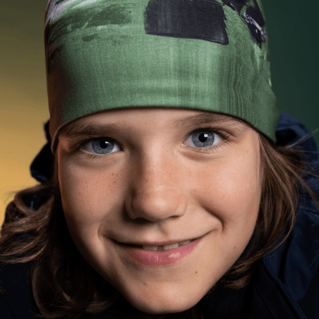 Close up of boy with blue eyes wearing the green Amazonia bamboo hat for men and children  illustrated by Megan Fortin 