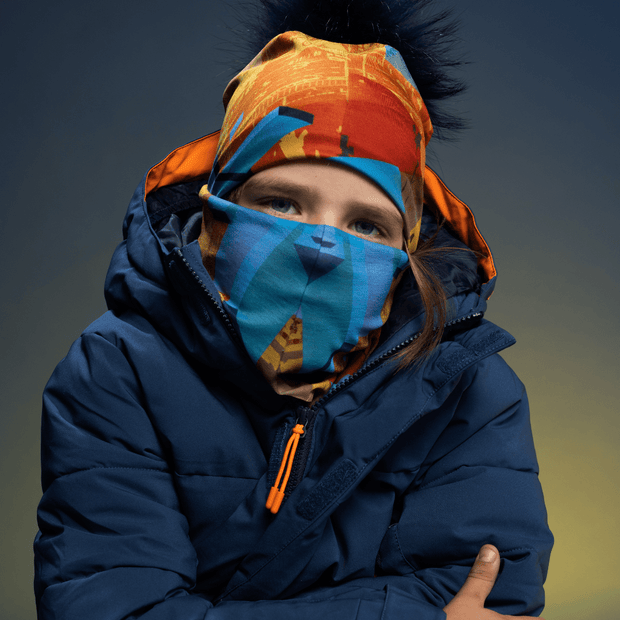 Kid wearing the Blue and Orange Montreal polar tube and assorted beanie from Ankhone for Lalita's Art Shop.