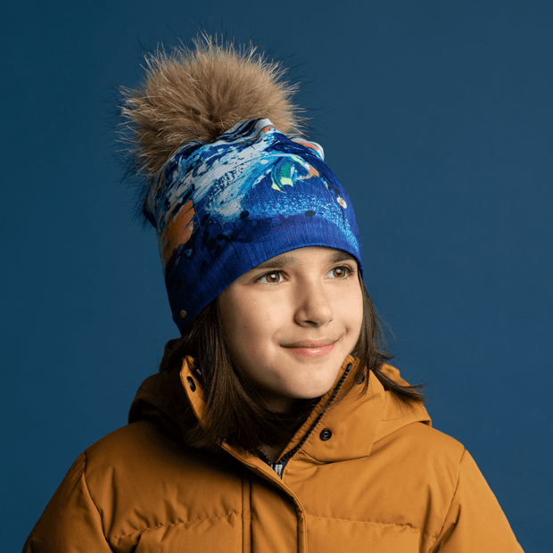 Girl with the bamboo wearable art beanie with natural fur pompom. 