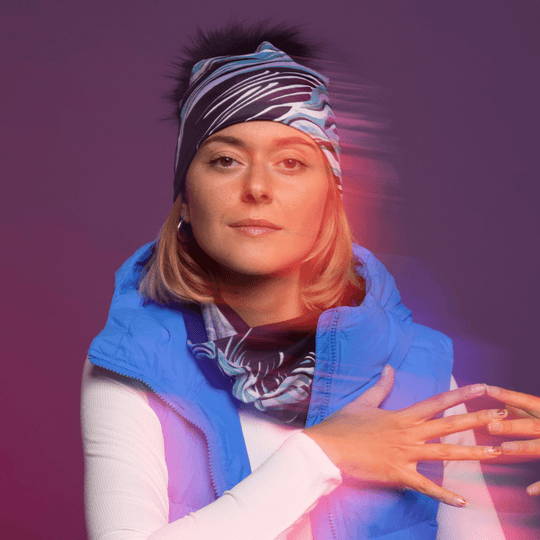 Sportive woman wearing the Heron Black and Blue Multifunctional tube with assorted pompom beanie for Lalita&