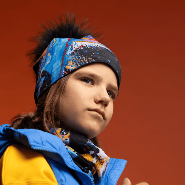 Kid wearing the Black and Blue Matrix Beanie with pompom and assorted tube by Megane Fortin for Lalita's Art Shop