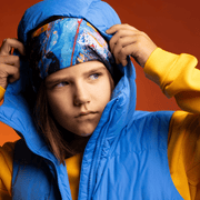 Boy wearing the Black and Blue Matrix multifunctional tube as headwear under his hood for the Lalita's ArtShop 24 collection