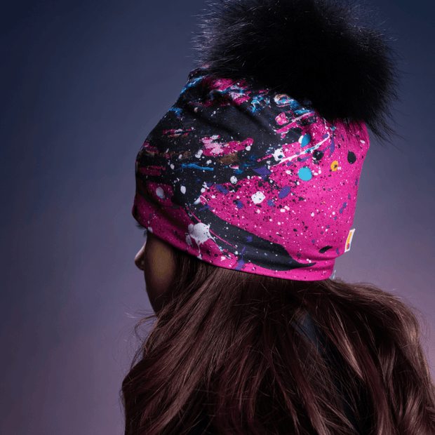 Teen girl showing a right view of the Pink, black and blue abstract patterned bamboo tuque by Lalita's Art Shop illustrated by painter Megane Fortin.