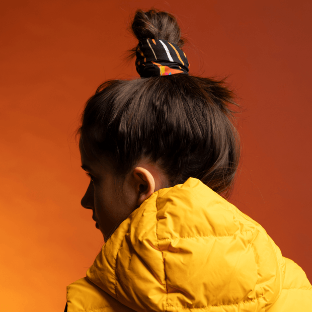 Teenager wearing the Orange Owl bandana as a cute and multifunctional hair accessory for Lalita's Art Shop