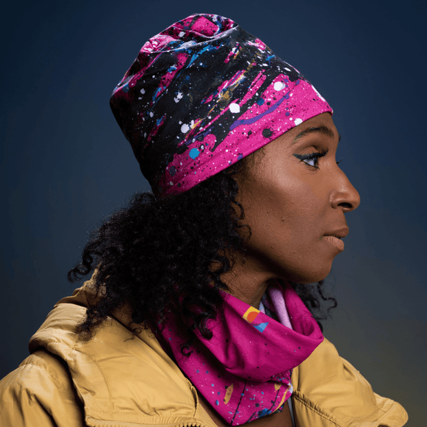 Woman with curly hair wearing the pair multipurpose bandana / training beanie hat Nest by Lalita's Art Shop with a yellow/gold spring jacket. 