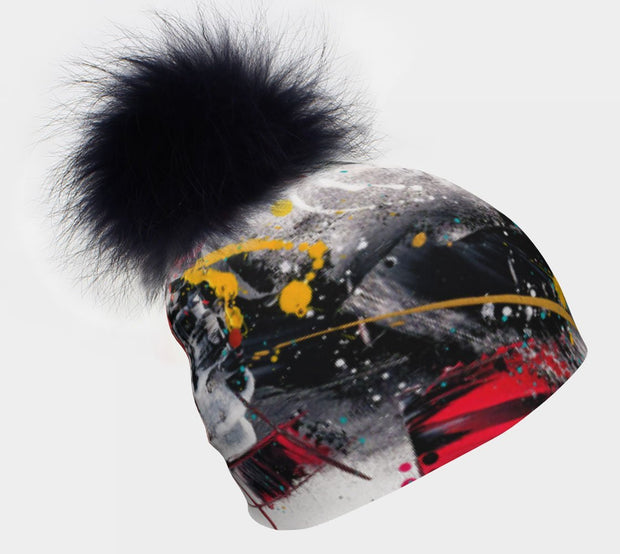 Right view of the black, red and white pompom beanie hat. Perfect for crosscountry skiing, your walk in the fall or winter. 