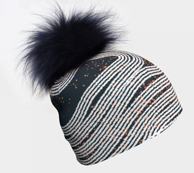 Dark Steel Beanie with detachable navy pompom. Beautifull dark grey color with an abstract white and orange pattern. 