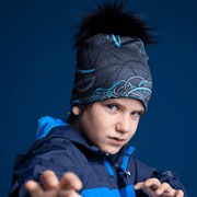 Young boy doing karate, wearing the Robocat 4seasons beanie designed by André Martel. The bamboo sports beanie hat has a black pompom