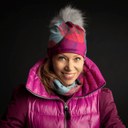 Woman wearing the fashion teal with red, magenta and greydot pattern beanie