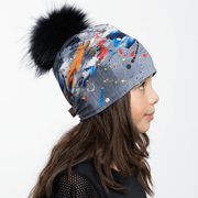 Left Side view of girl wearing abstract modern unisex toque with black pompon.