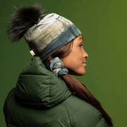 Sportive woman wearing the Gray and Green Wall Pompom beanie from Lalita's Art Shop