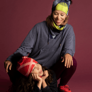 Mother and daughter wearing the new collection of accessories by Valery Goulet for Lalita's Art Shop. The daughter is wearing the Peachy-Red beanie with black Pom and the woman is wearing the Yellow-Dots beanie and neckgater