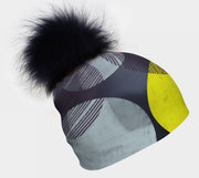 Left side view of the abstract pattern beanie Yellow-Dots with black real fur pom. 