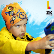 Boy in action wearing the The Zombie Kidz Bike Hero! This yellow, black and white  bamboo beanie was illustrated by illustrator NIKAO for the Zombie Kidz game by the canadian editor Scorpion Masqué. 