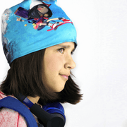 Side view of kid's tuque  created in collaboration with Canadian editor scorpion masque illustrating a young skater girl hero chasing zombies ! 